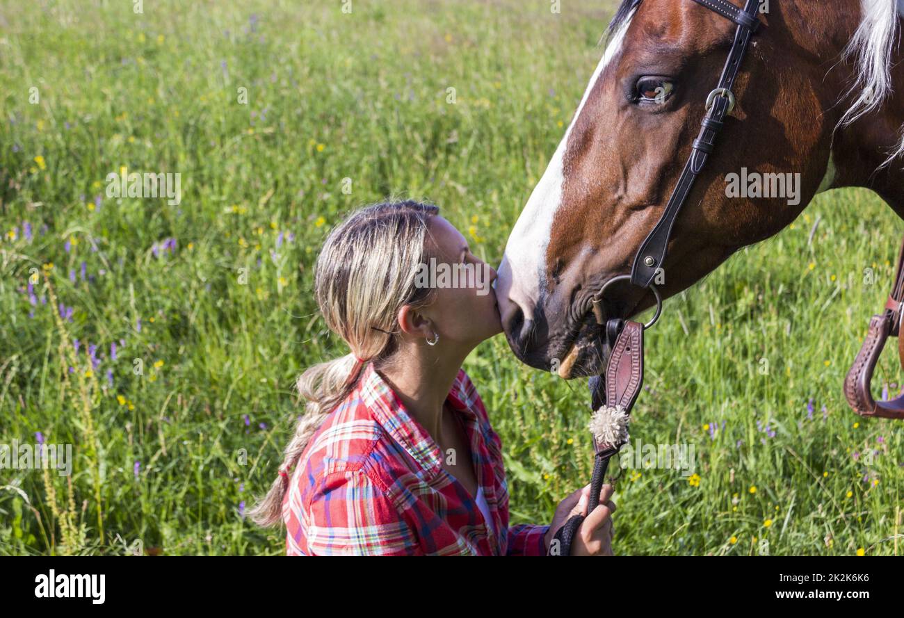 Young girl kissing her horse Stock Photo