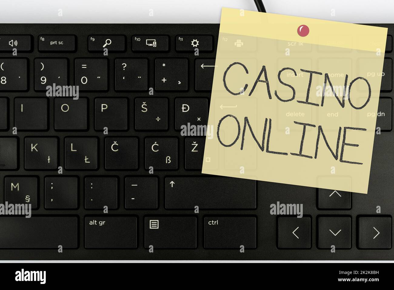 Writing displaying text Casino Online. Word for Computer Poker Game Gamble Royal Bet Lotto High Stakes Computer Keyboard And Symbol.Information Medium For Communication. Stock Photo