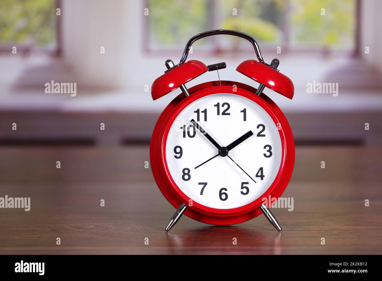 Red traditional alarm clock in room differential focus Stock Photo