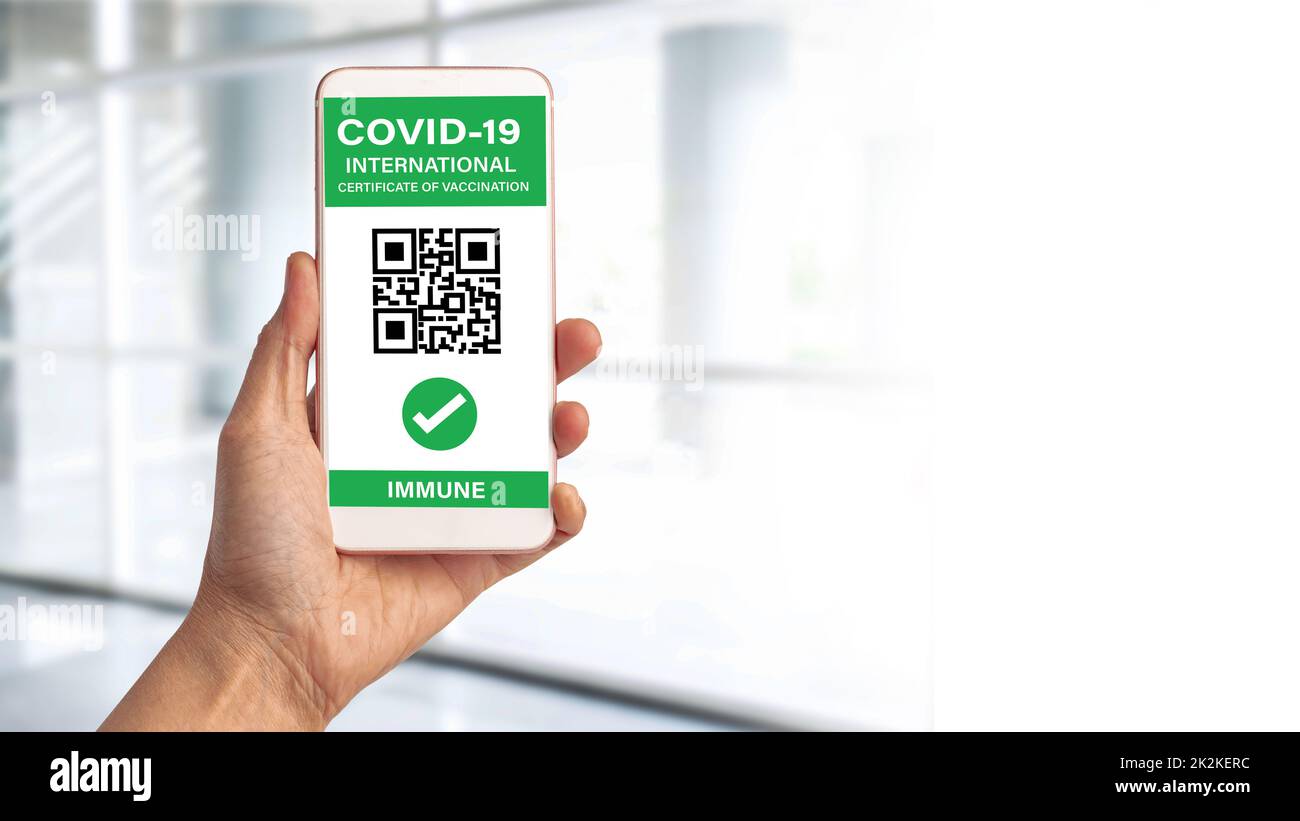 Digital health covid-19 passport showing screen QR code international certificate of vaccination for working, travel and transportation. Stock Photo