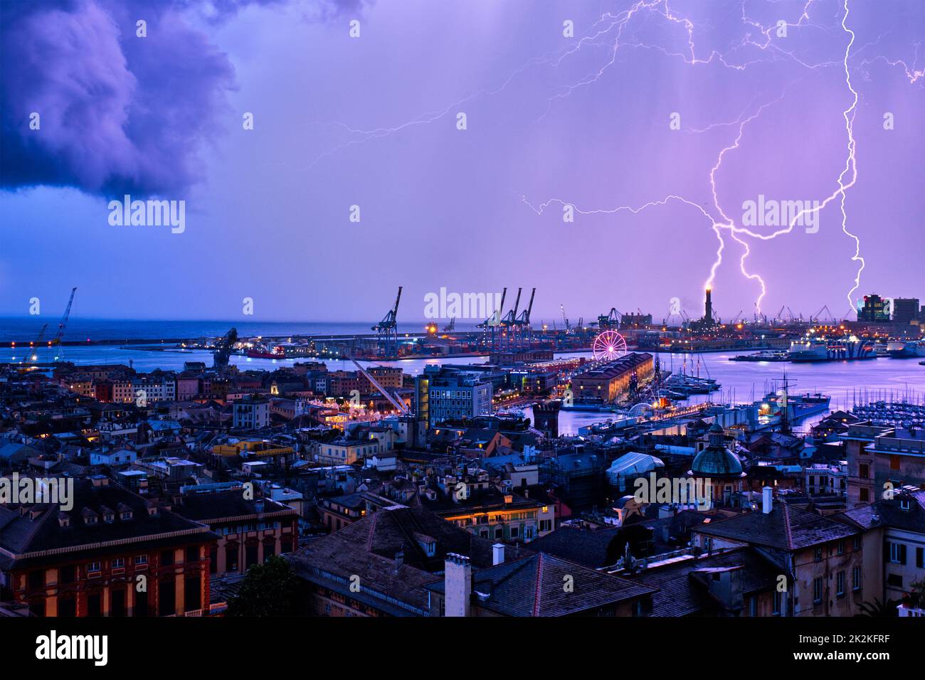 Evening view of Genoa port with thunderstorm and lighting, Italy Stock Photo