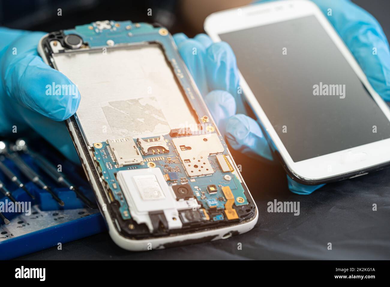 Technician repairing inside of mobile phone by soldering iron. Integrated Circuit. the concept of data, hardware, technology. Stock Photo