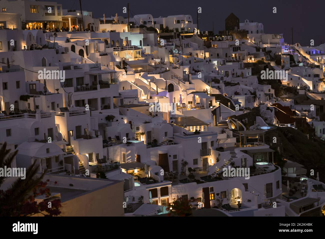 Illuminated whitewashed houses with terraces and pools and a beautiful view in Imerovigli on Santorini island Stock Photo