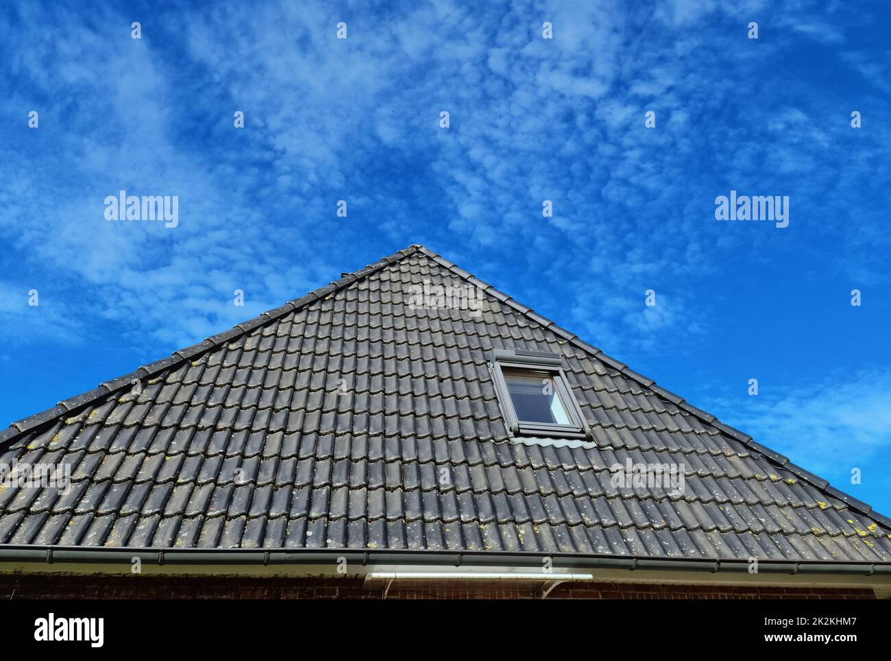 Open roof window in velux style with black roof tiles Stock Photo Alamy
