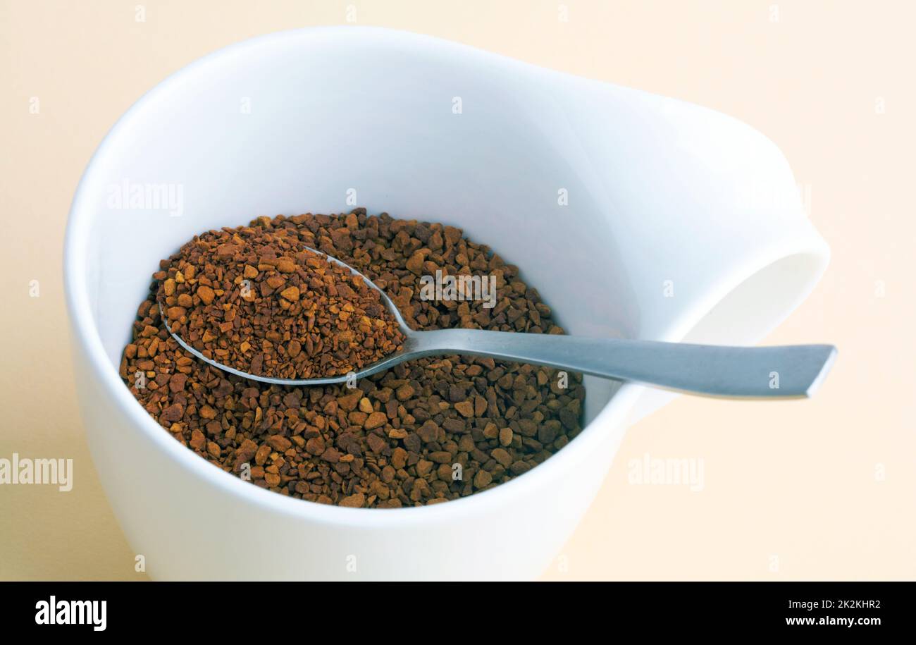 Powdered Coffee in a white cup over bright background Stock Photo