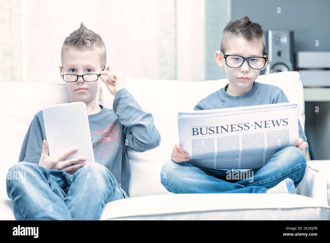 Spoof of two young boys wearing glasses posing as businessmen Stock Photo