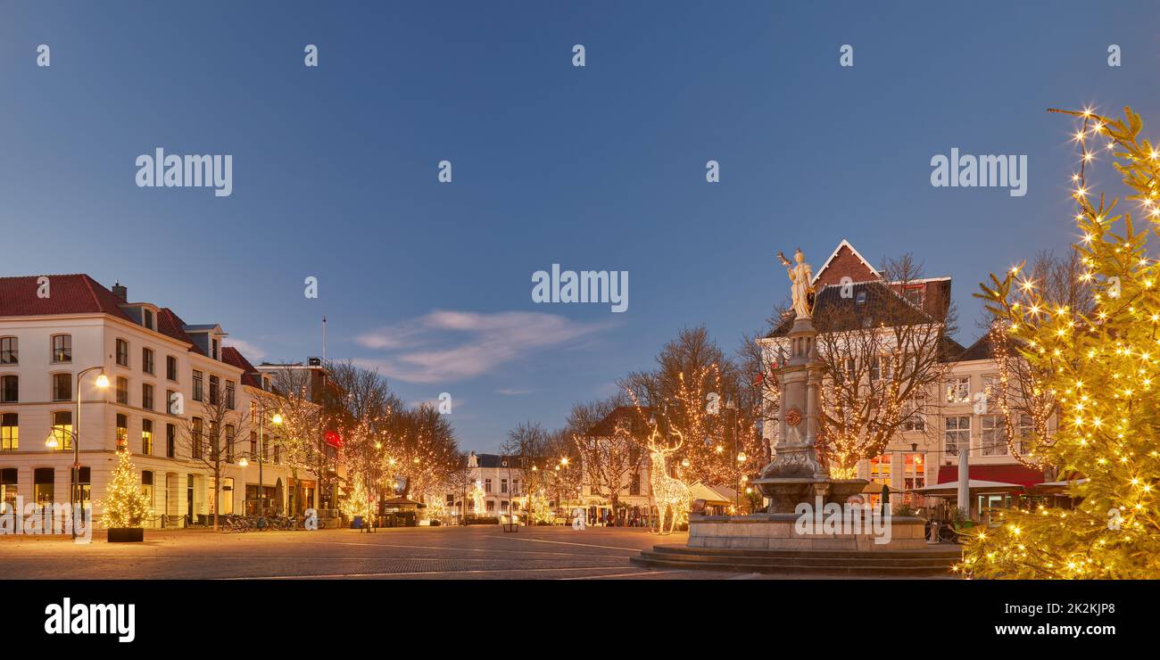 The central Brink square in the historic Dutch city Deventer in winter with christmas trees and decoration Stock Photo