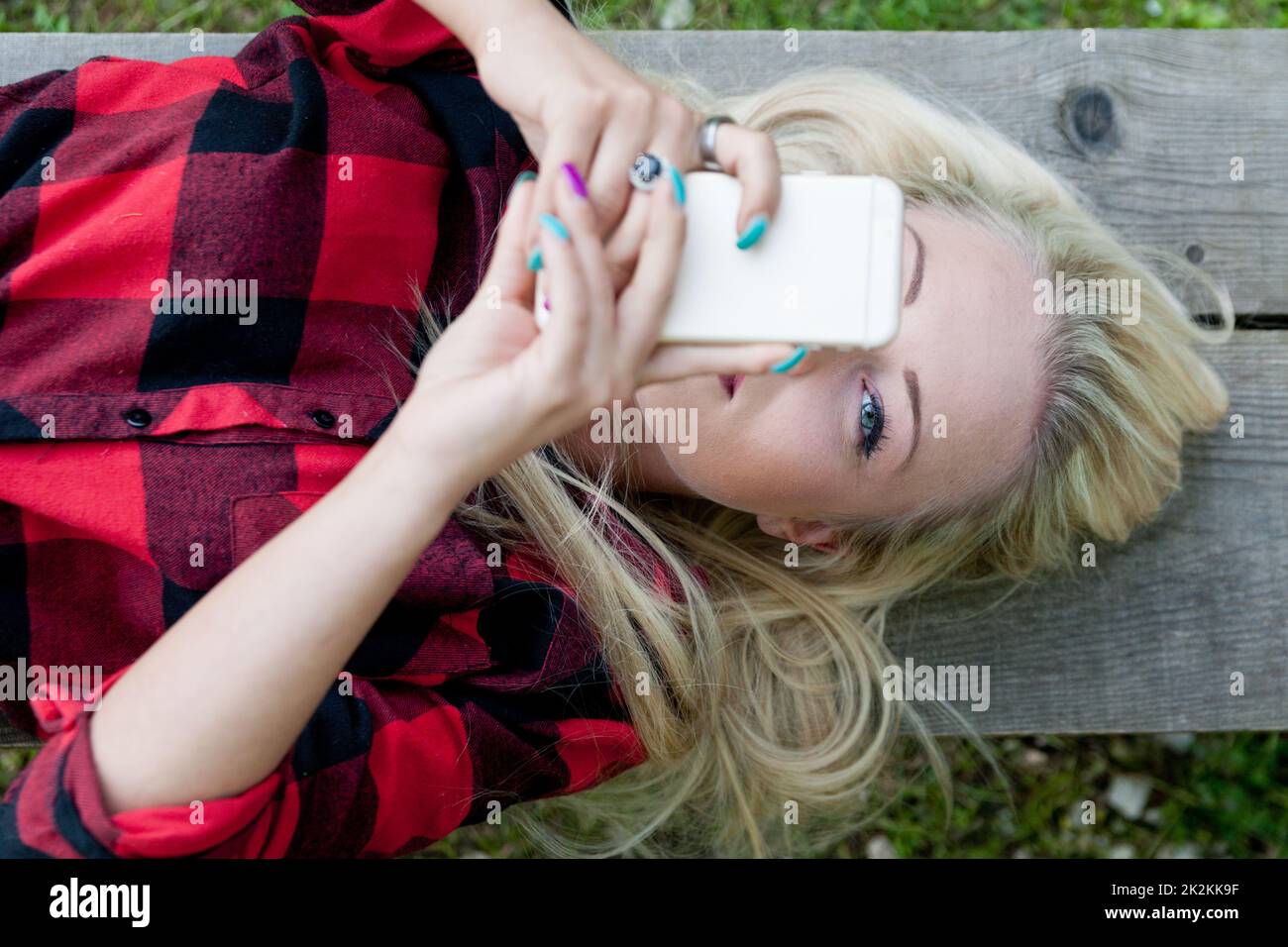 eye of a girl spotting you from behind the phone Stock Photo