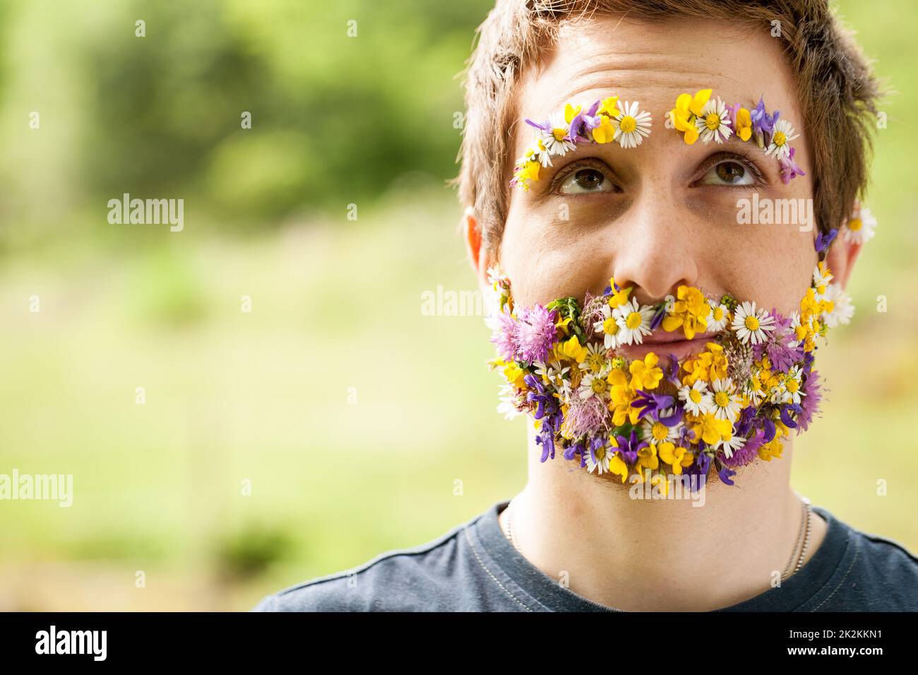 portrait of a guy with flowers instead of his beard Stock Photo Alamy