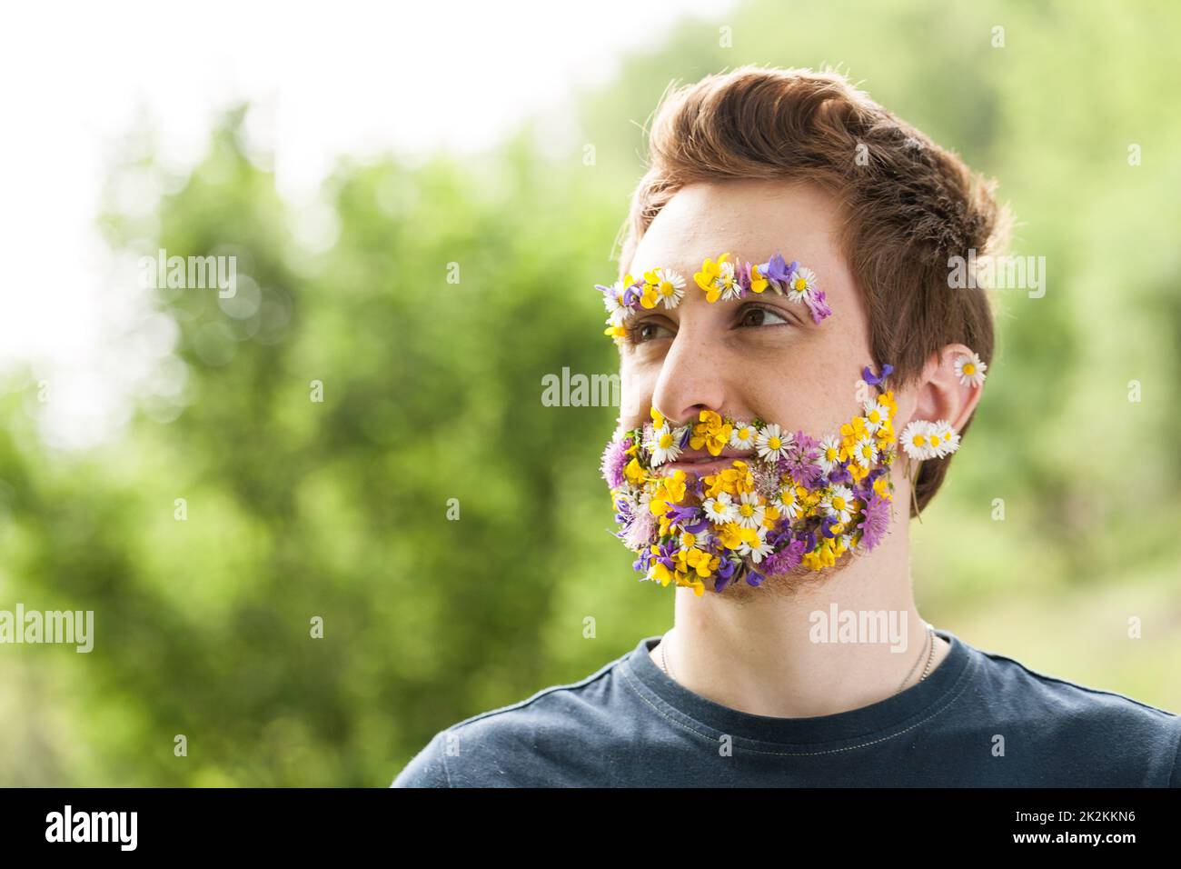 portrait of a guy with flowers instead of his beard Stock Photo Alamy