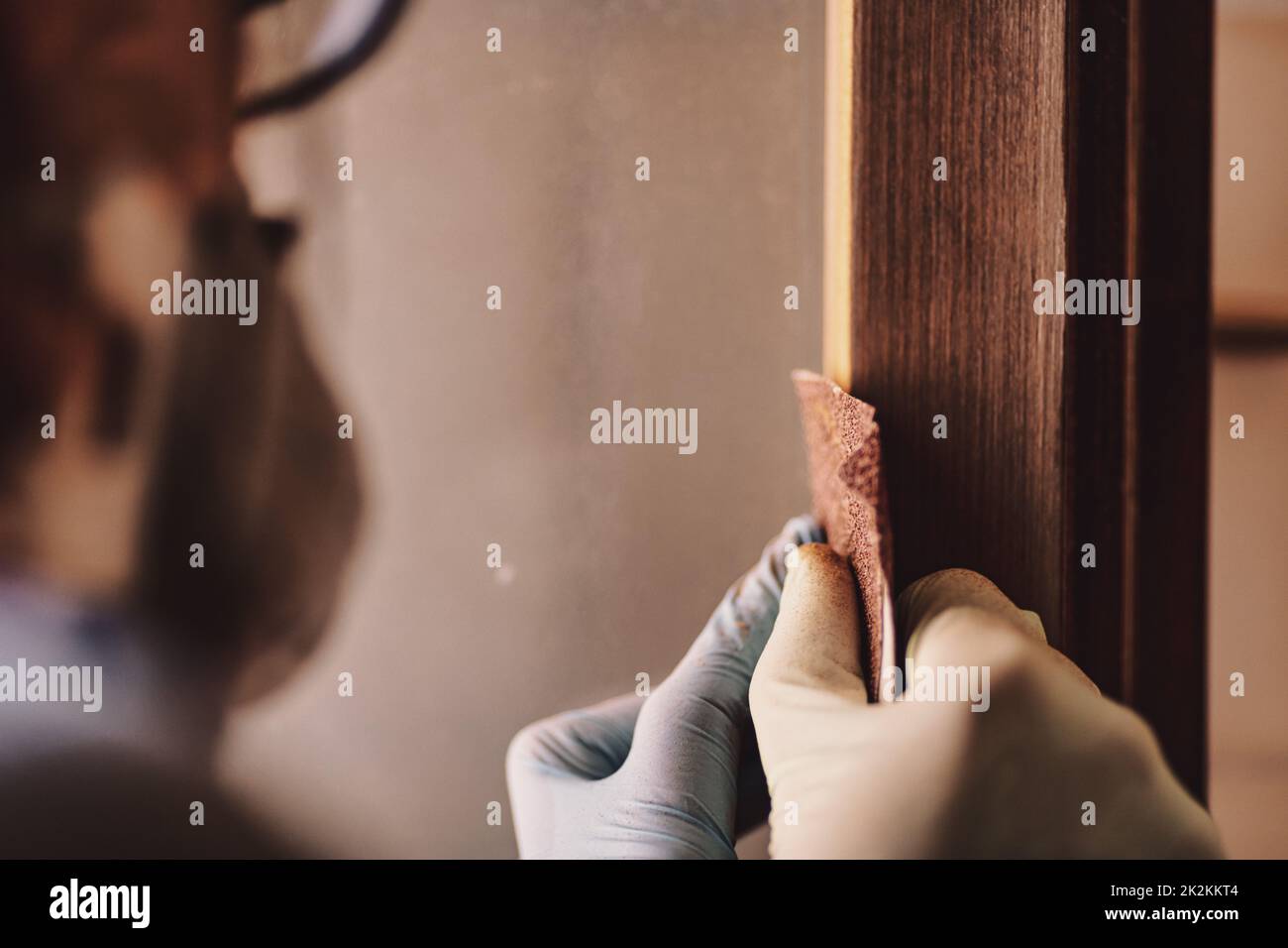 woman hands sandpaper and repair windows and wooden frames Stock Photo