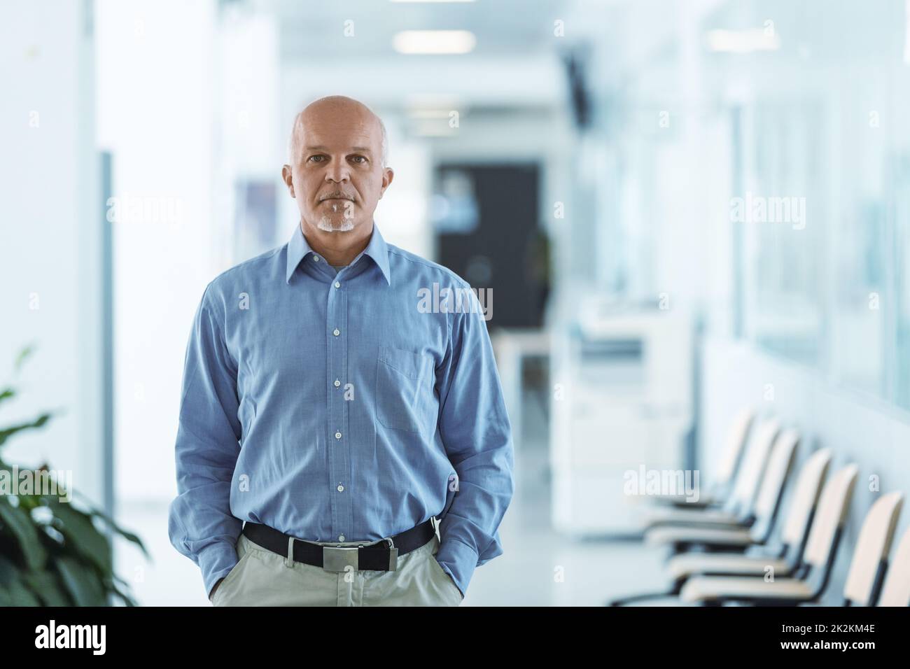 senior man standing and facing the camera with hands in pocket Stock Photo