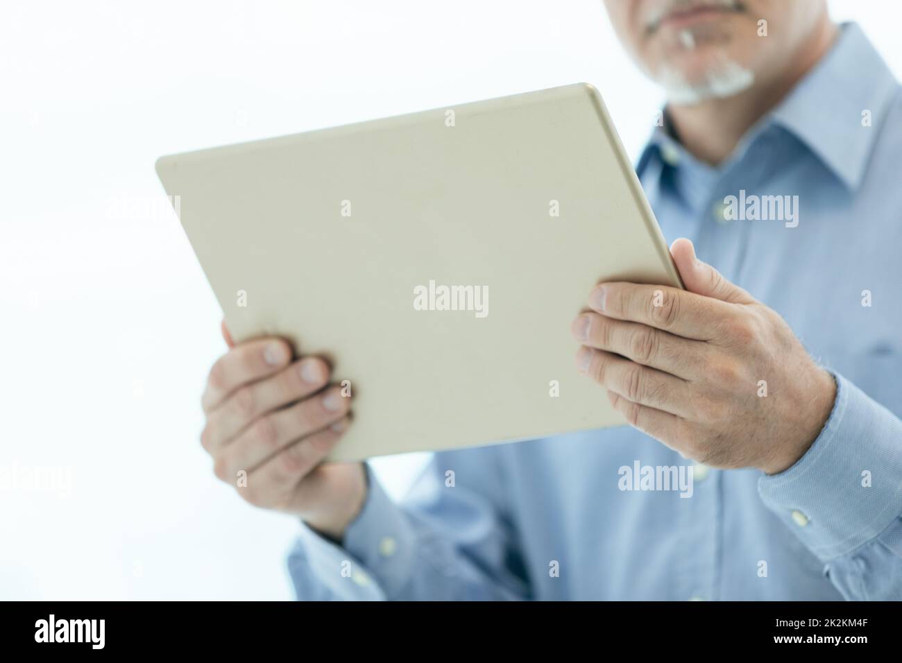 Businessman holding a tablet-pc in his hands Stock Photo