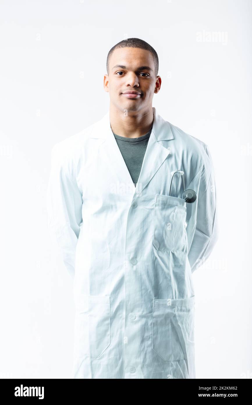 Confident young Black male doctor in white lab coat Stock Photo