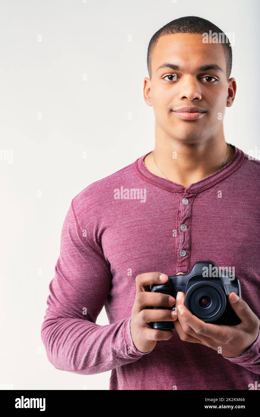 Cropped vertical portrait of an attractive Black man with camera Stock Photo