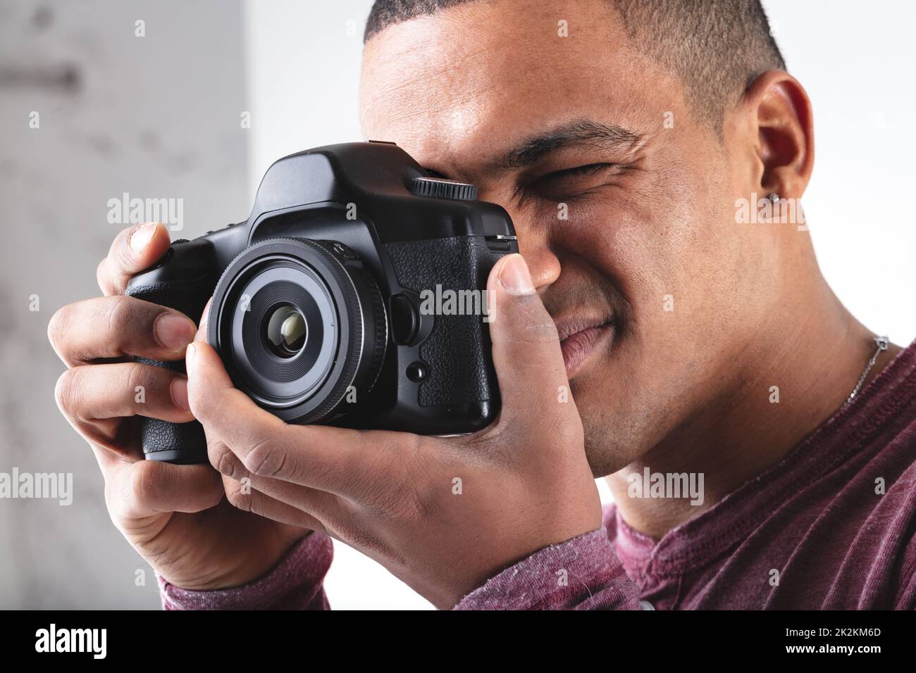 Young male photographer composing his image on camera Stock Photo