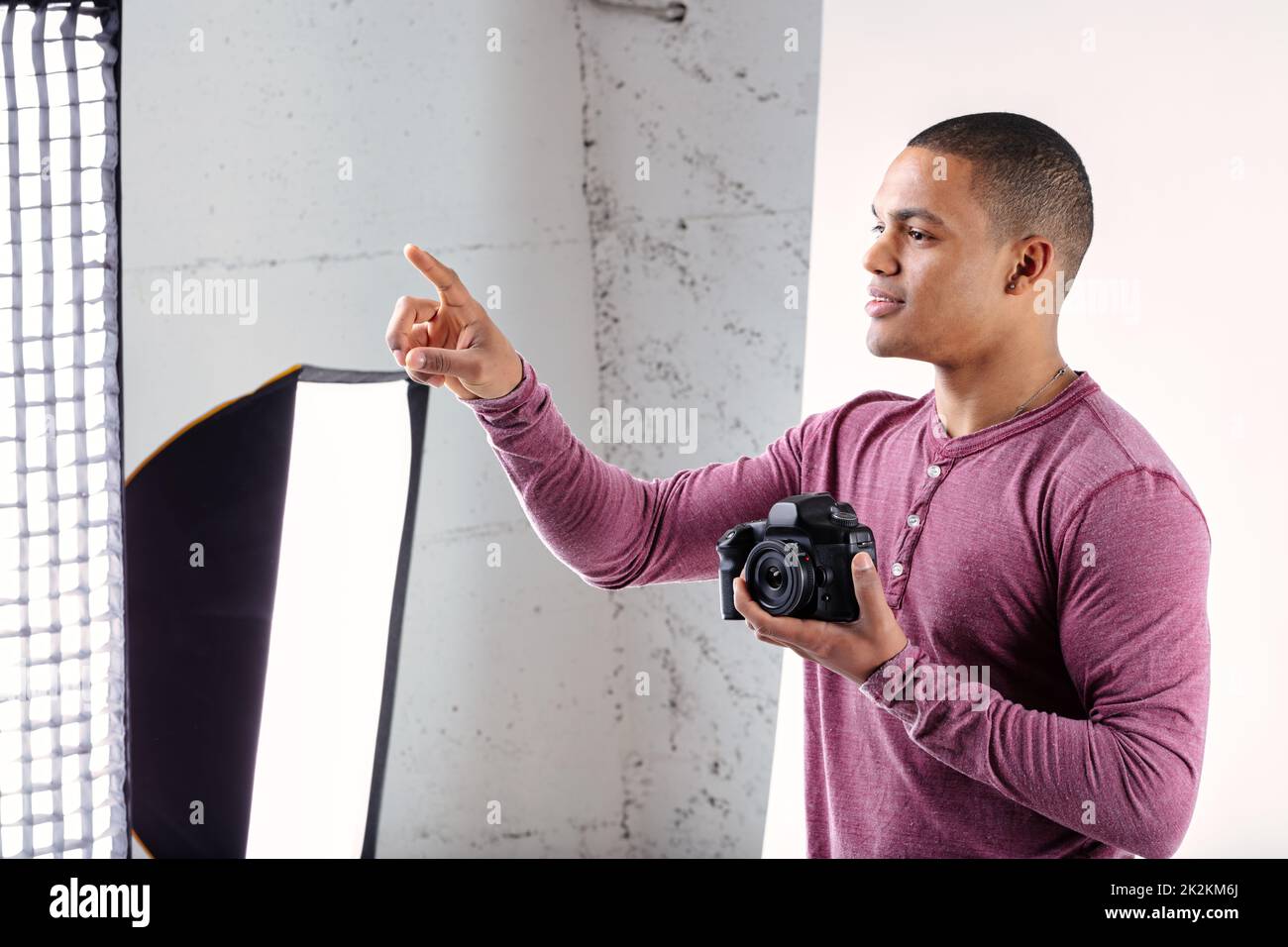 Young Black photographer giving instructions during a shoot Stock Photo