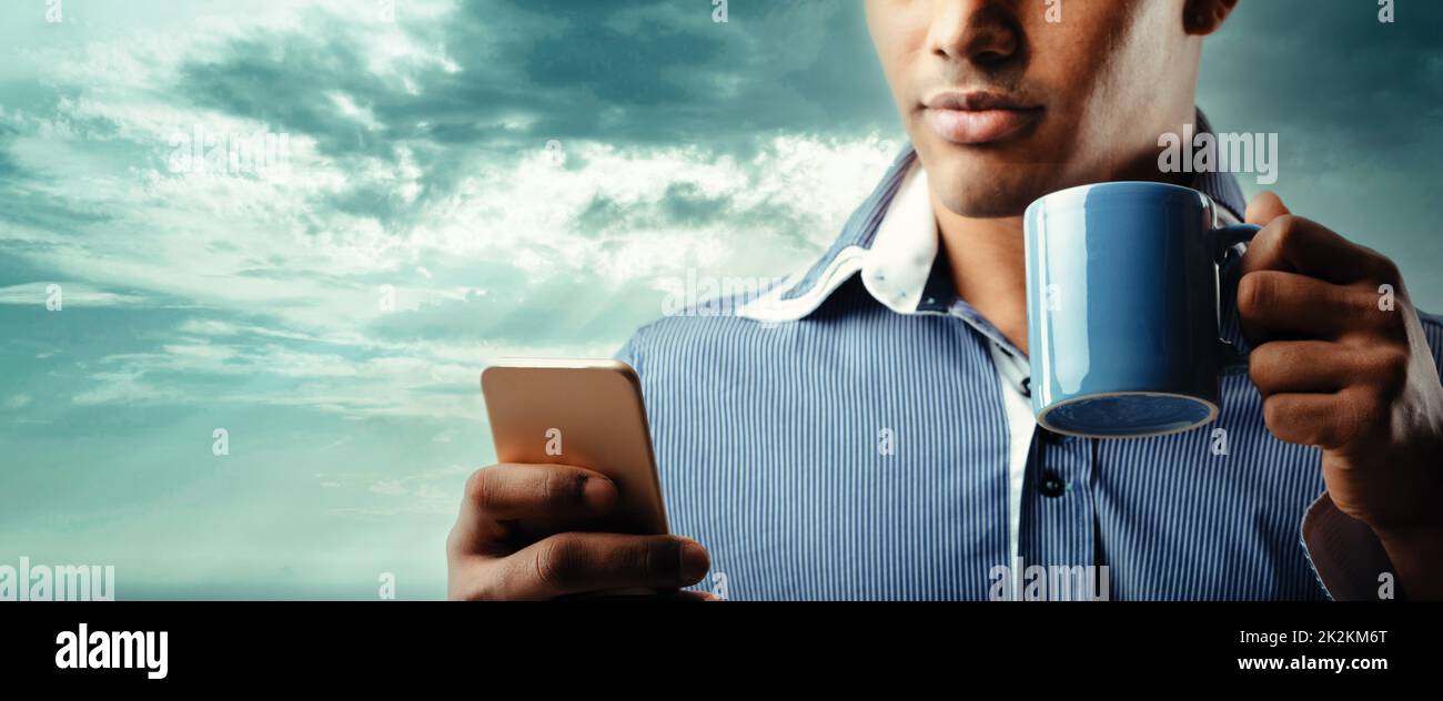 Panorama banner of a Black man using a mobile phone Stock Photo