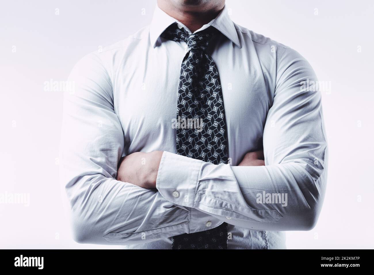 Cropped view of the chest of a man with folded arms Stock Photo
