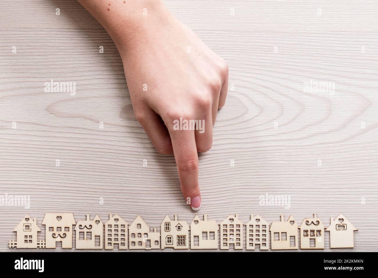 Mini Figure Pointing hand pointing out a house among the others mini figures in a micro ...