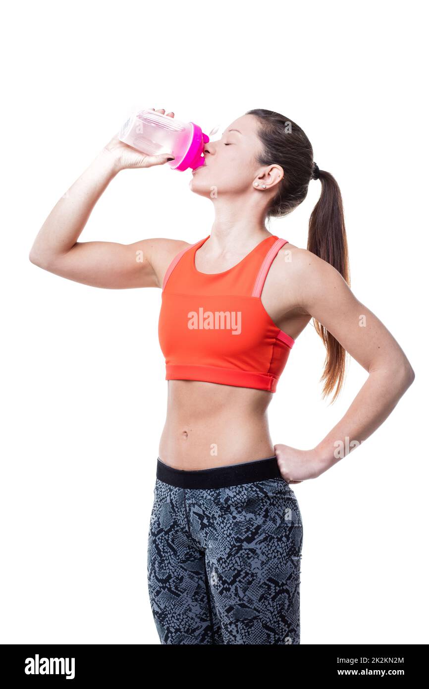 drinking before after and during her workout Stock Photo