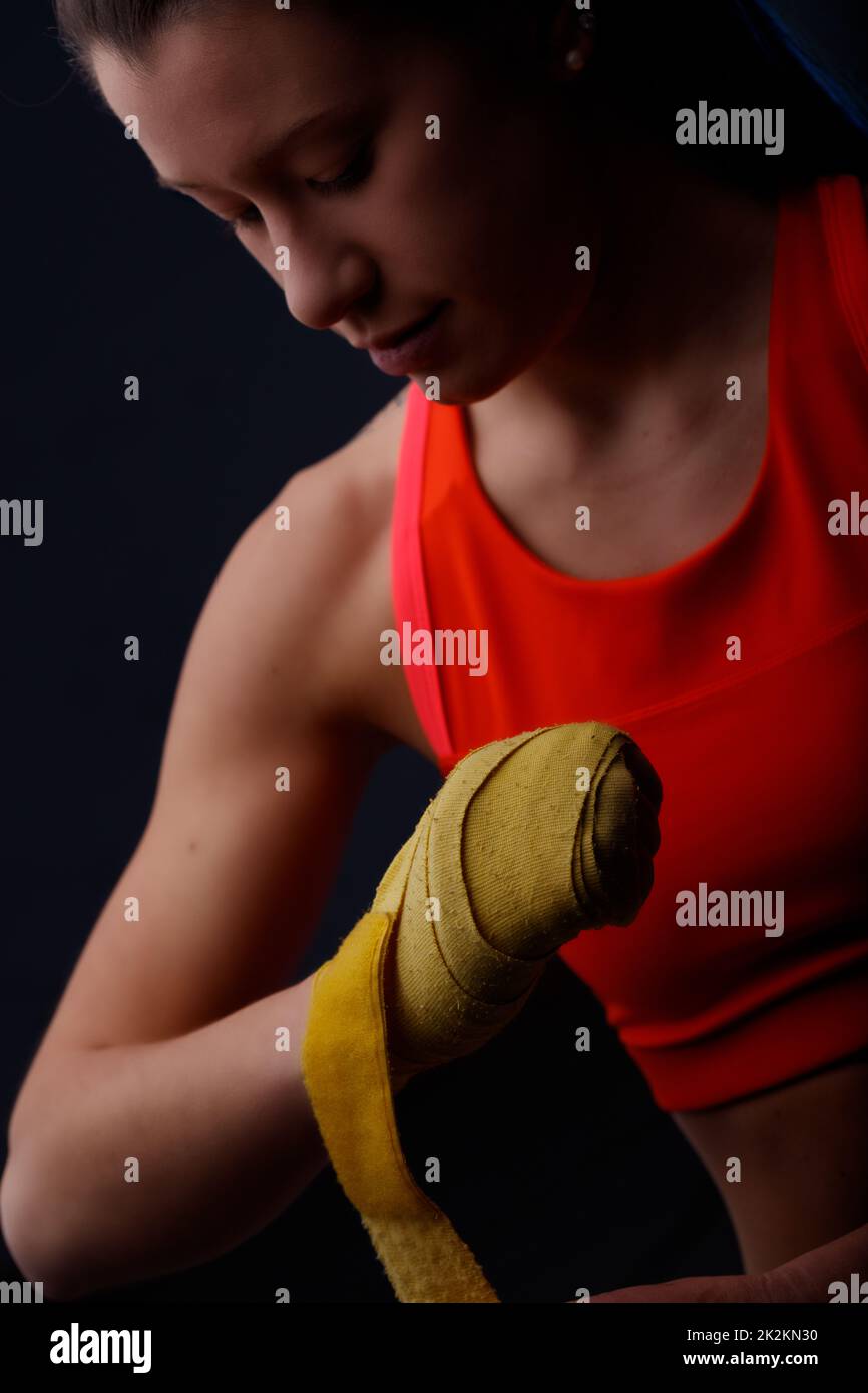 Woman wrapping her fists with yellow hand wraps Stock Photo Alamy