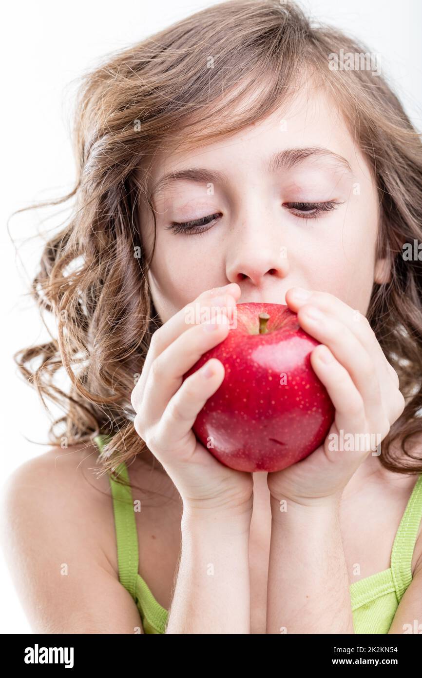girl biting a red apple on white background Stock Photo Alamy