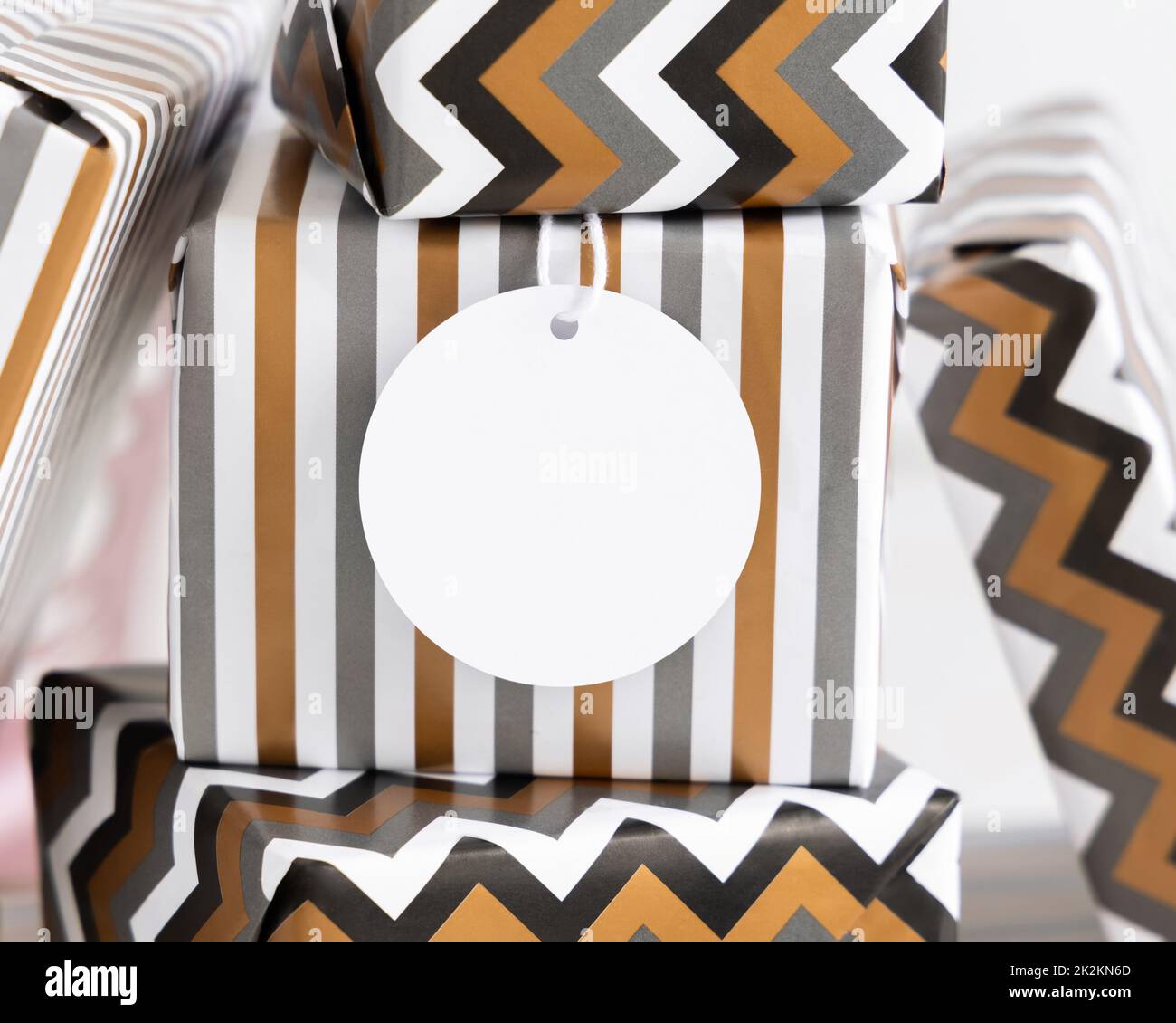 Wrapped present with blank round gift tag close up, label Mockup Stock