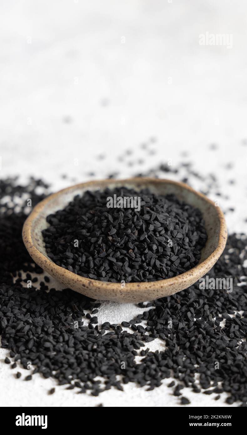 Indian spice Black cumin (nigella sativa or kalonji) seeds in bowl close up Stock Photo