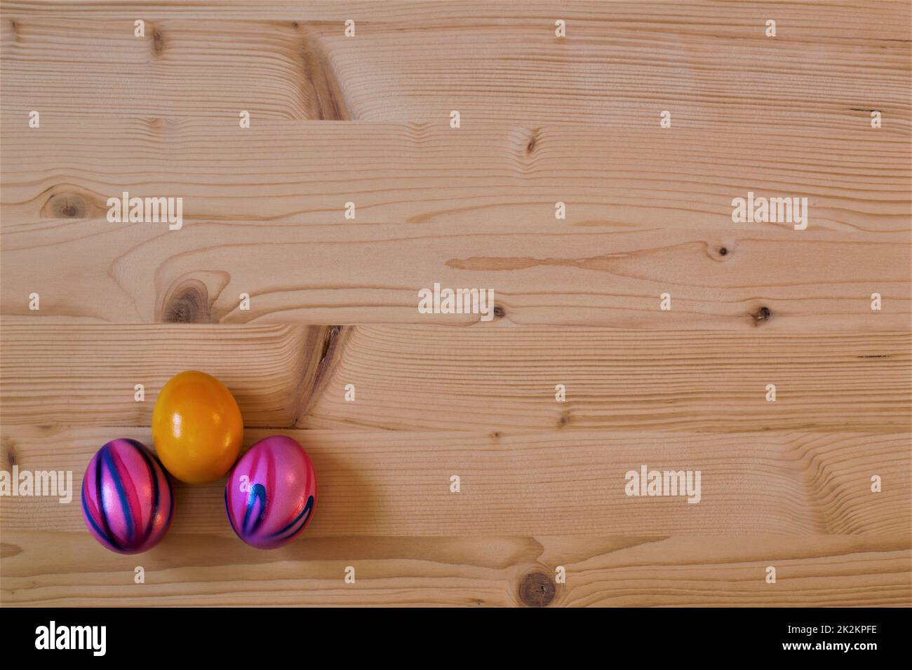 easter eggs laying on wood, background wallpaper Stock Photo