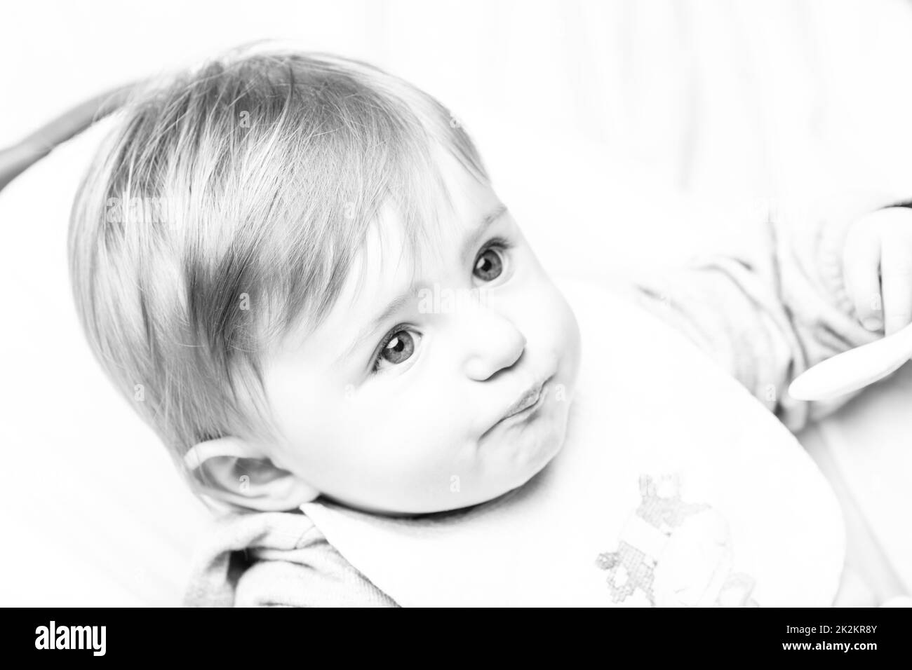 infant girl black and white candid portrait Stock Photo