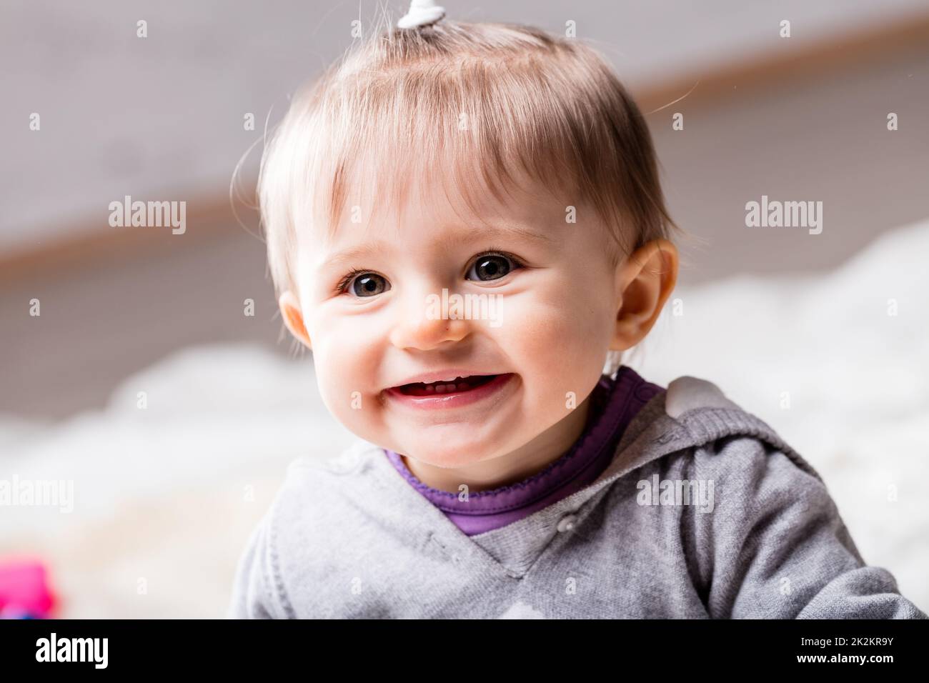 Something Smiling little children looking at something and smiling Stock Photo - Alamy