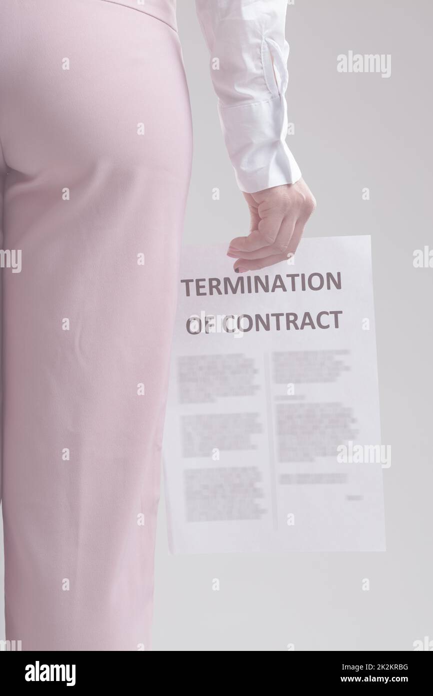 Partial view of a businesswoman holding termination of Contract Stock Photo