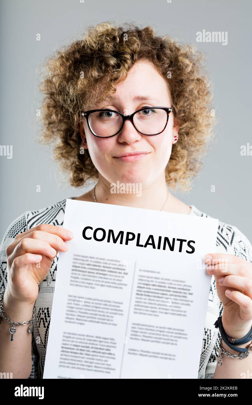 unhappy woman showing a complaints form Stock Photo Alamy