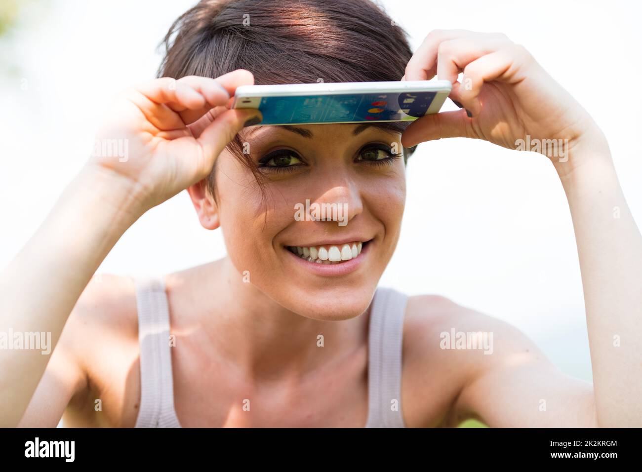 woman smiling and protecting from the sun Stock Photo