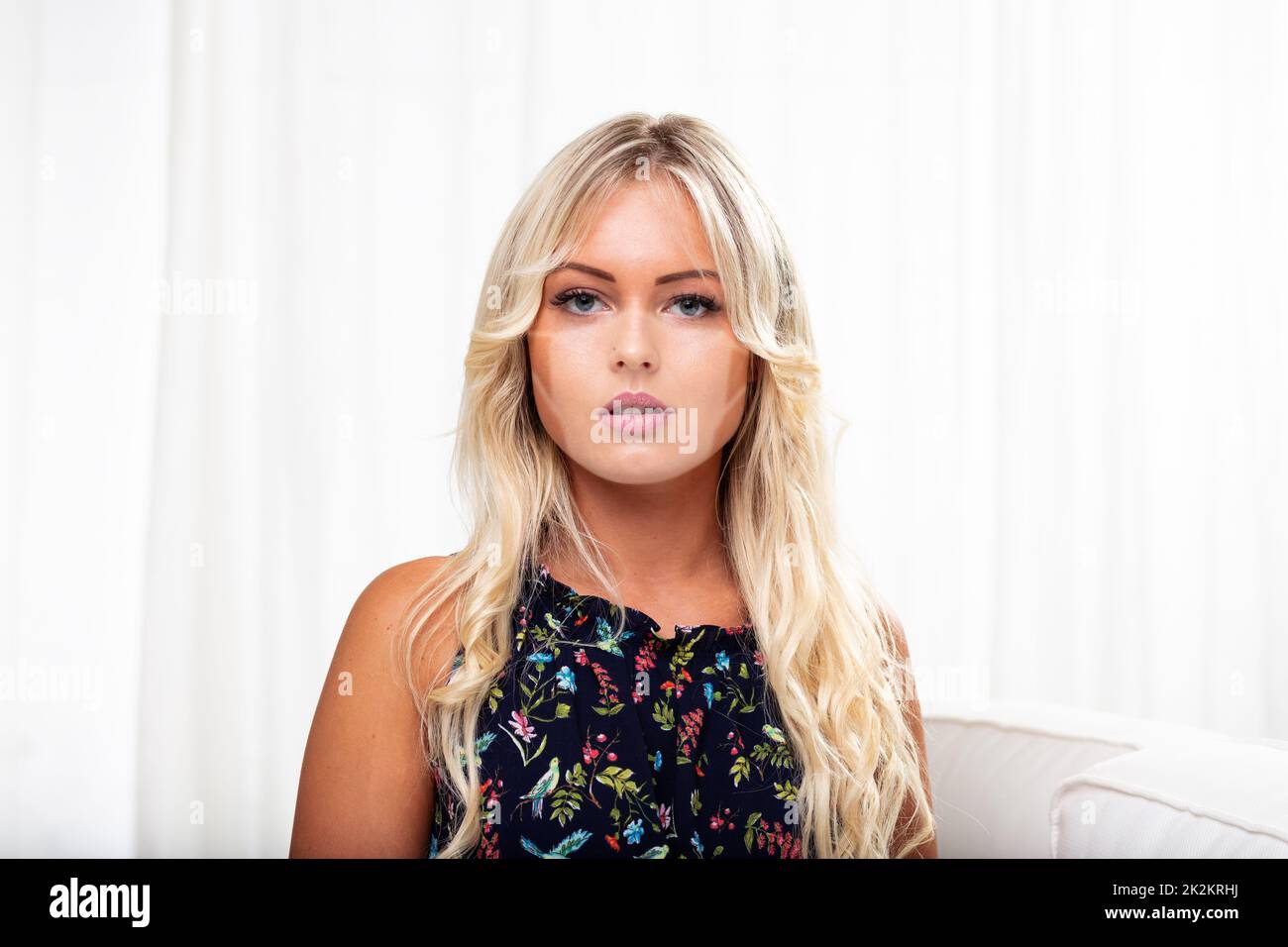 young blonde woman with mask tan lines on her face Stock Photo