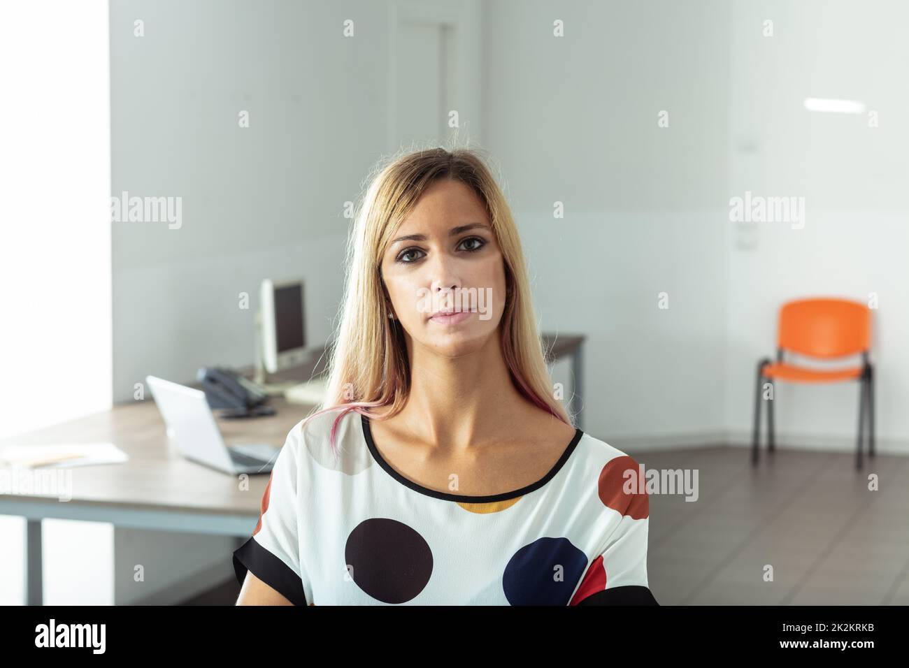 business woman with tan lines of a protective mask because of COVID19 Stock Photo
