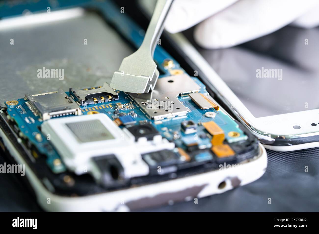 Technician repairing inside of smartphone, Integrated Circuit. the concept of data, hardware, technology. Stock Photo
