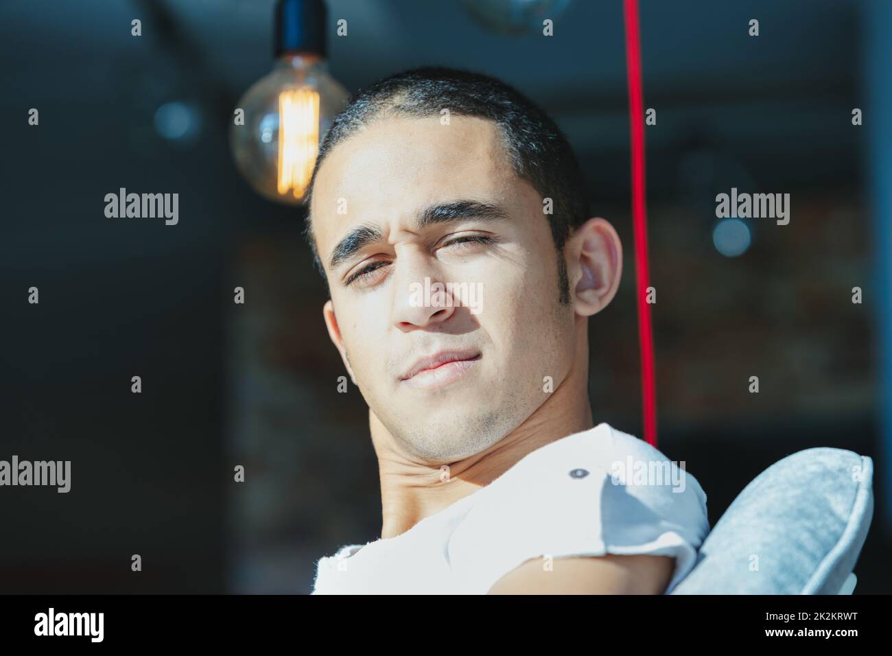 Puzzled young man staring intently at the camera Stock Photo