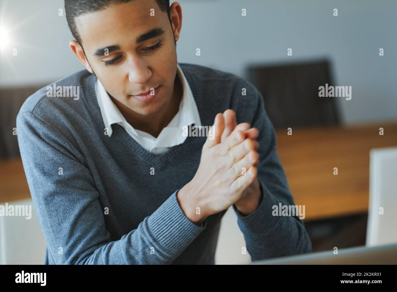 Young Black businessman in an open plan office Stock Photo