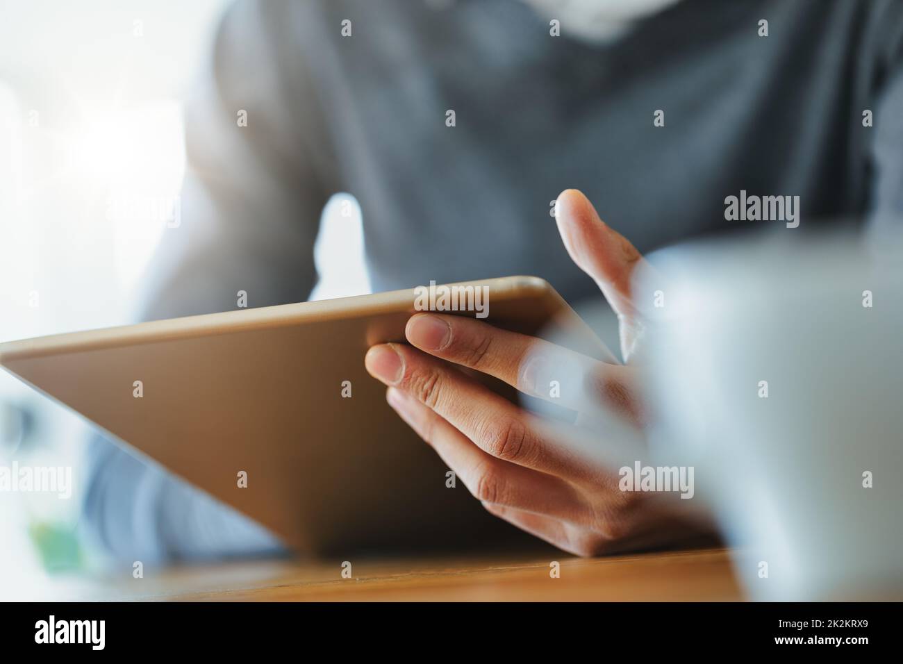 Hand of a Black man holding a tablet pc Stock Photo
