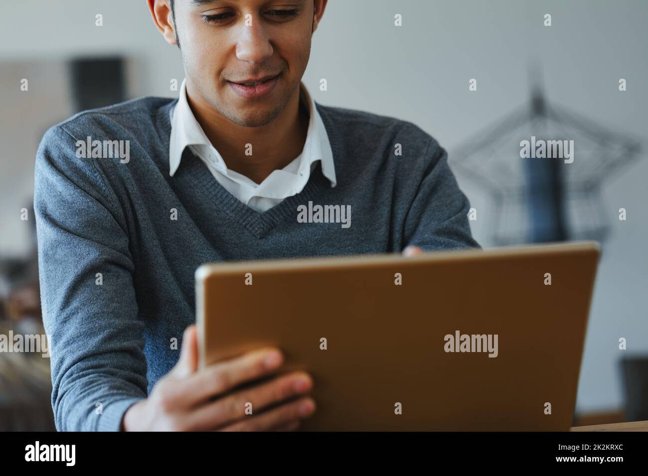 Young Black man reading or watching media on a tablet pc Stock Photo