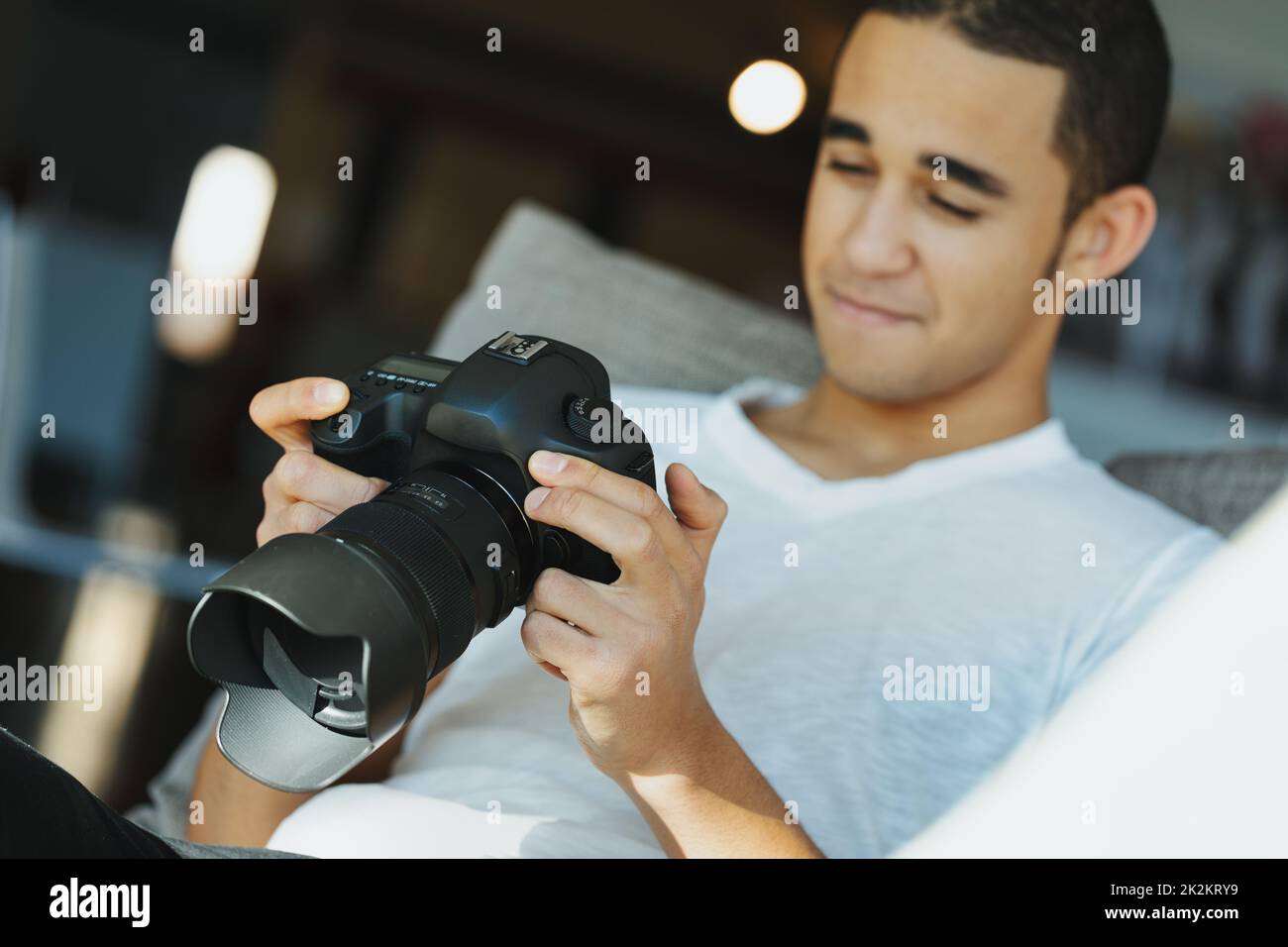 Young Black photographer chimping his photo on his camera Stock Photo