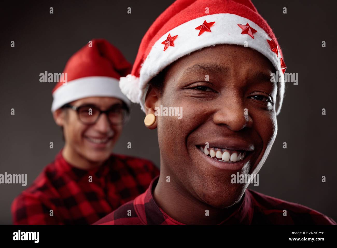 Happy smiling Black man wearing a red Santa hat for Christmas Stock Photo