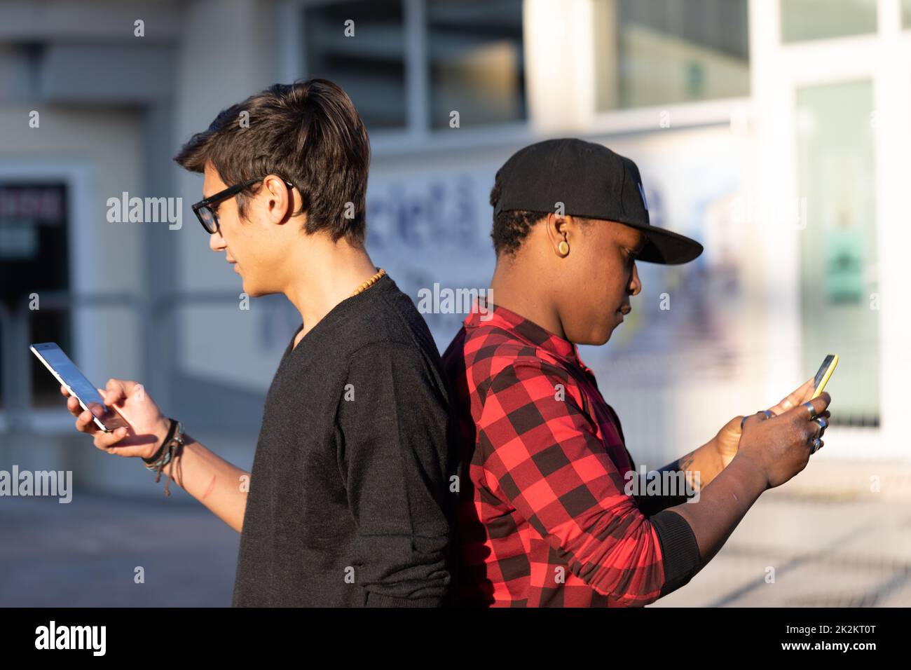 white guy and black guy ignoring each other Stock Photo