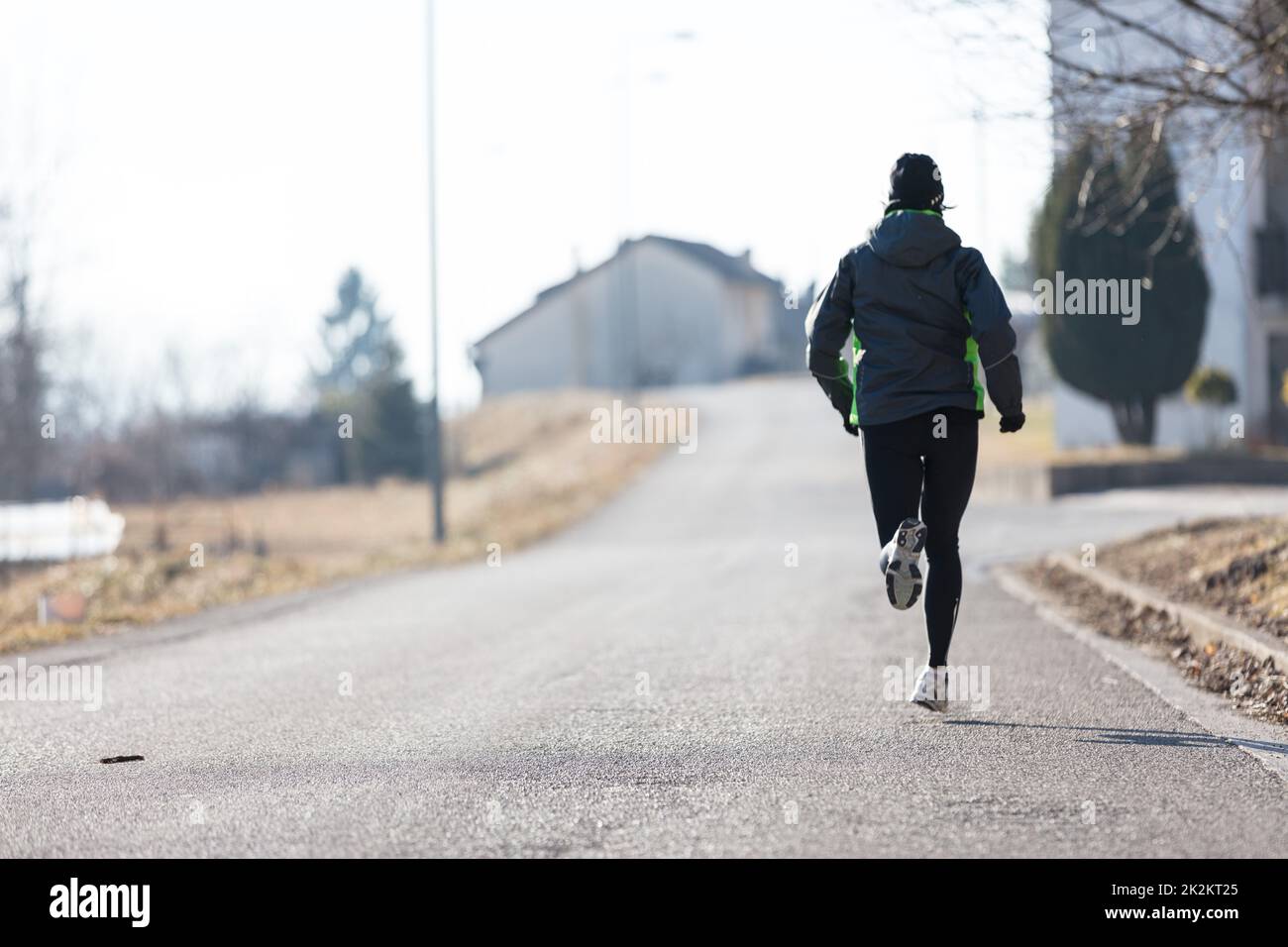 woman running from rear view in winter Stock Photo