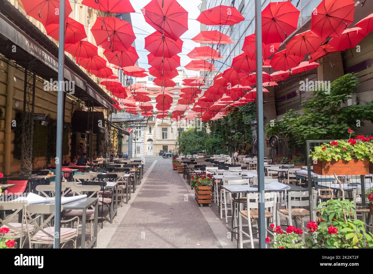 Belgrade, Serbia - June 7, 2022: Red umbrellas above Manufaktura Restaurant Belgrade. Stock Photo