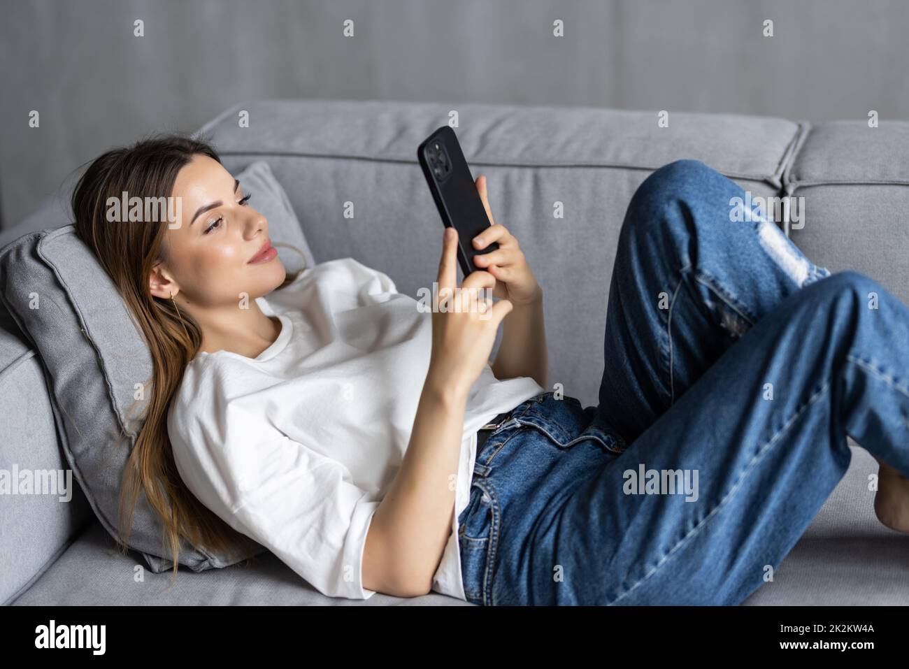 Barefoot girl lying on couch hi-res stock photography and images - Alamy