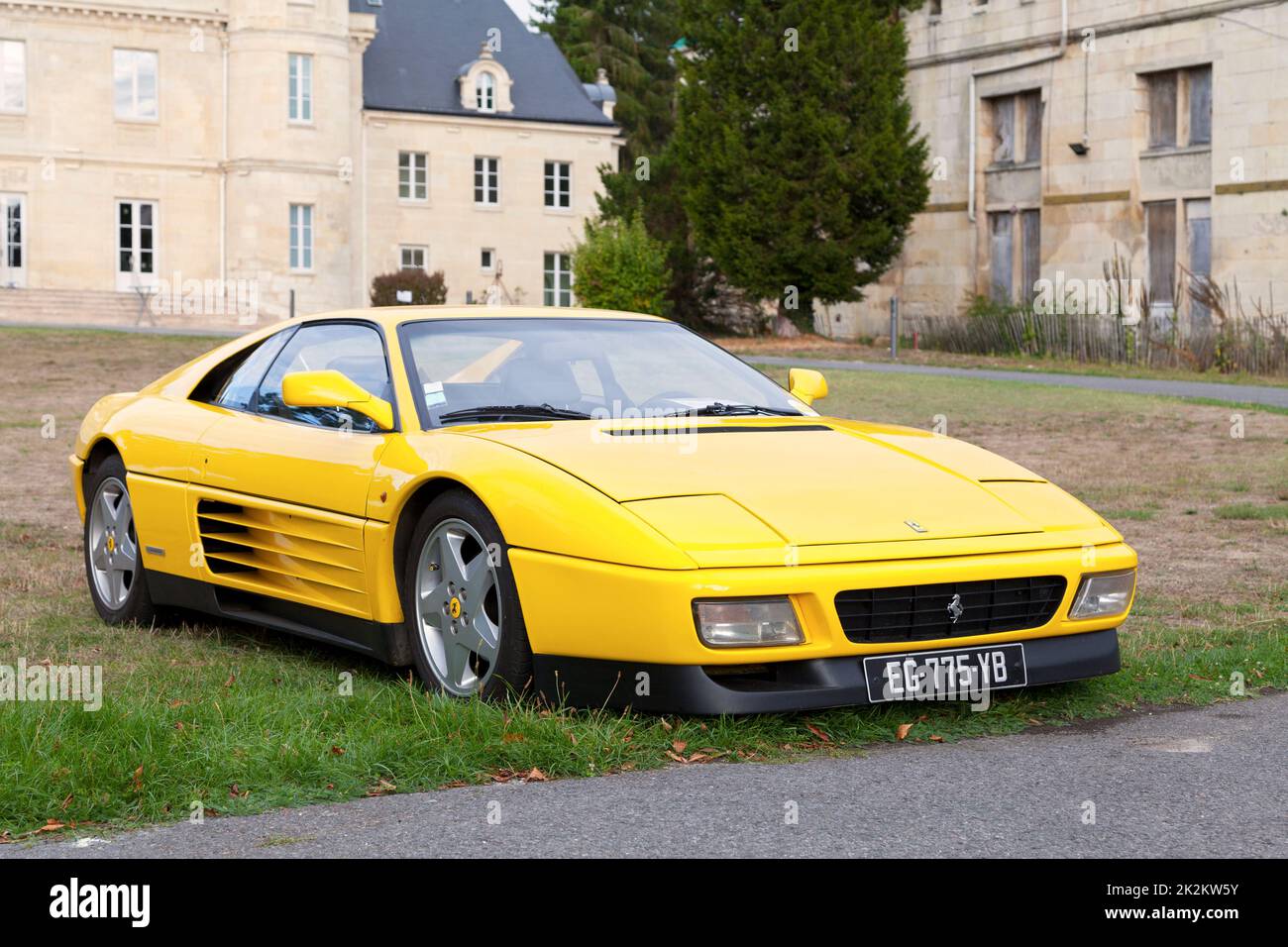 Lamorlaye, France -  September 06 2020: Yellow Ferrari 348 (Type F119), a mid-engine V8-powered 2-seat sports car produced by Italian automaker Ferrar Stock Photo