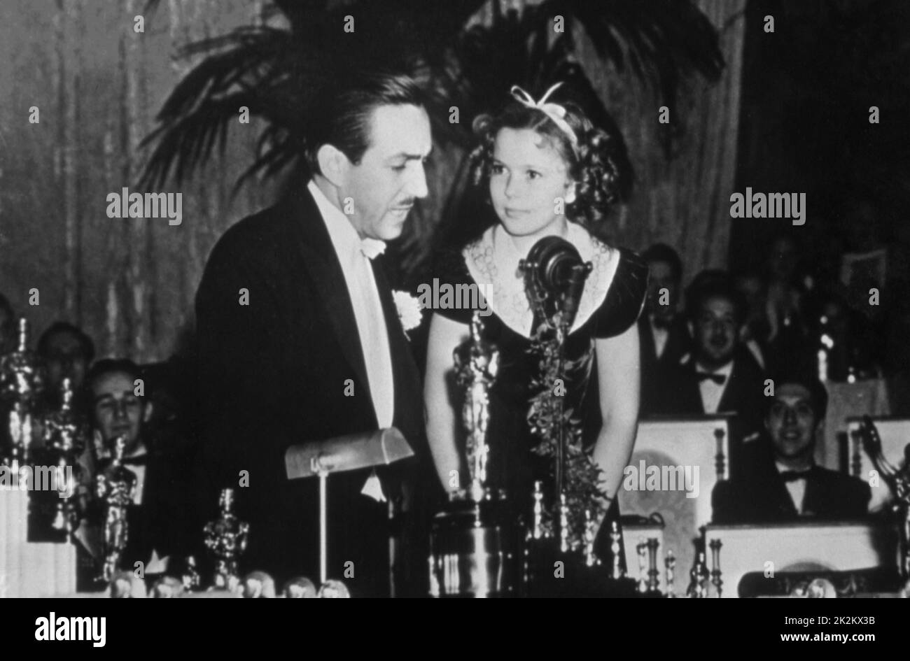 Shirley Temple and Walt Disney, Oscars ceremony in 1935. Shirley Temple receives the Juvenile Award In grateful recognition of her outstanding contribution to screen entertainment during the year 1934. Stock Photo